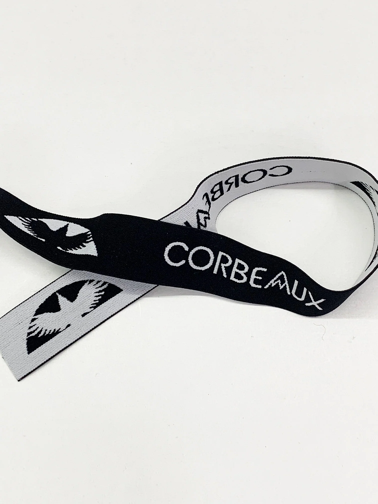 1 1/4" Black/Bright Silver Branded Text Medallion Jacquard Elastic - Corbeaux Clothing - BY THE 5 YARD PIECE